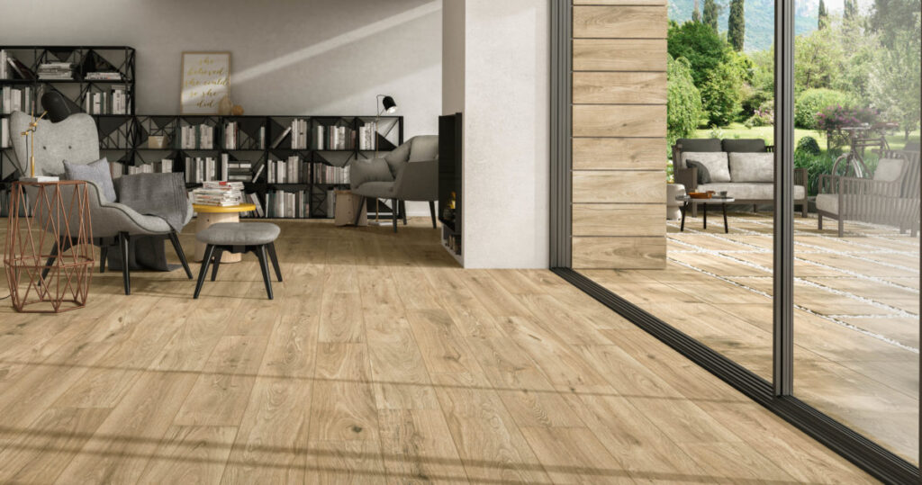 Keramische houtlook tegels in warme eiken uitstraling, doorlopend van woonkamer naar terras – Artstone